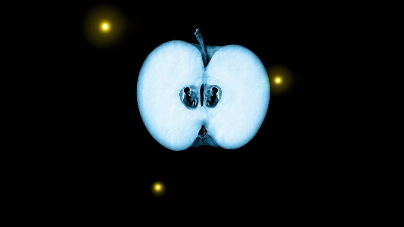 sliced apple with glowing lights