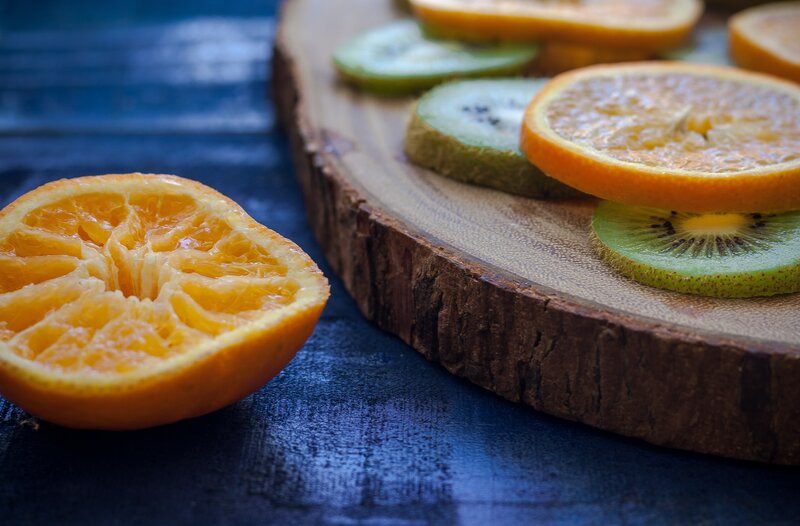 Sliced citrus and kiwi on wood