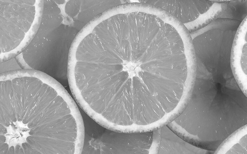 sliced citrus fruit in black and white