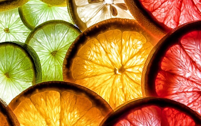 Sliced Citrus Fruits — Green, Vibrant, Photograph, Fruit Slices