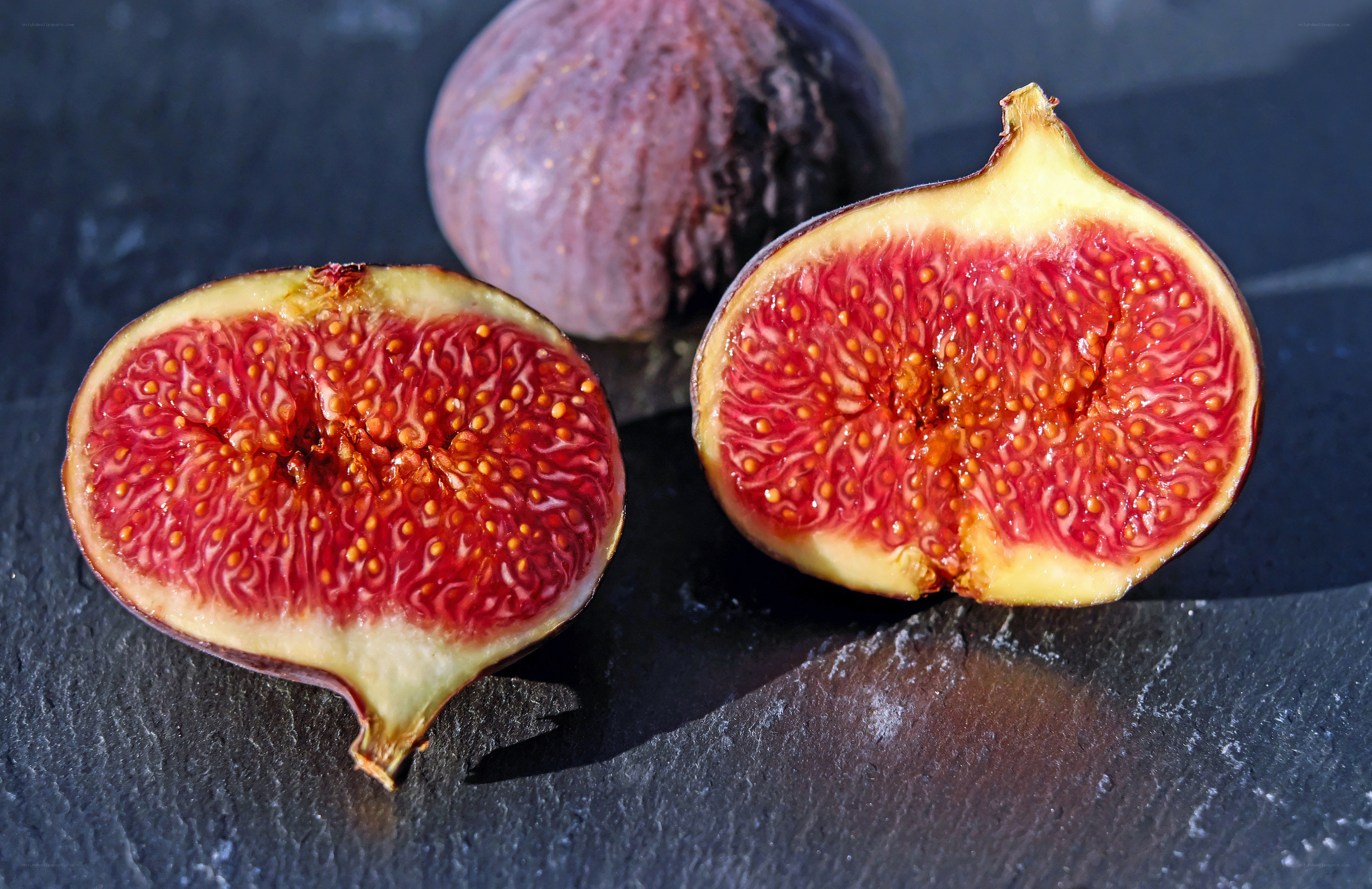 sliced figs on dark surface