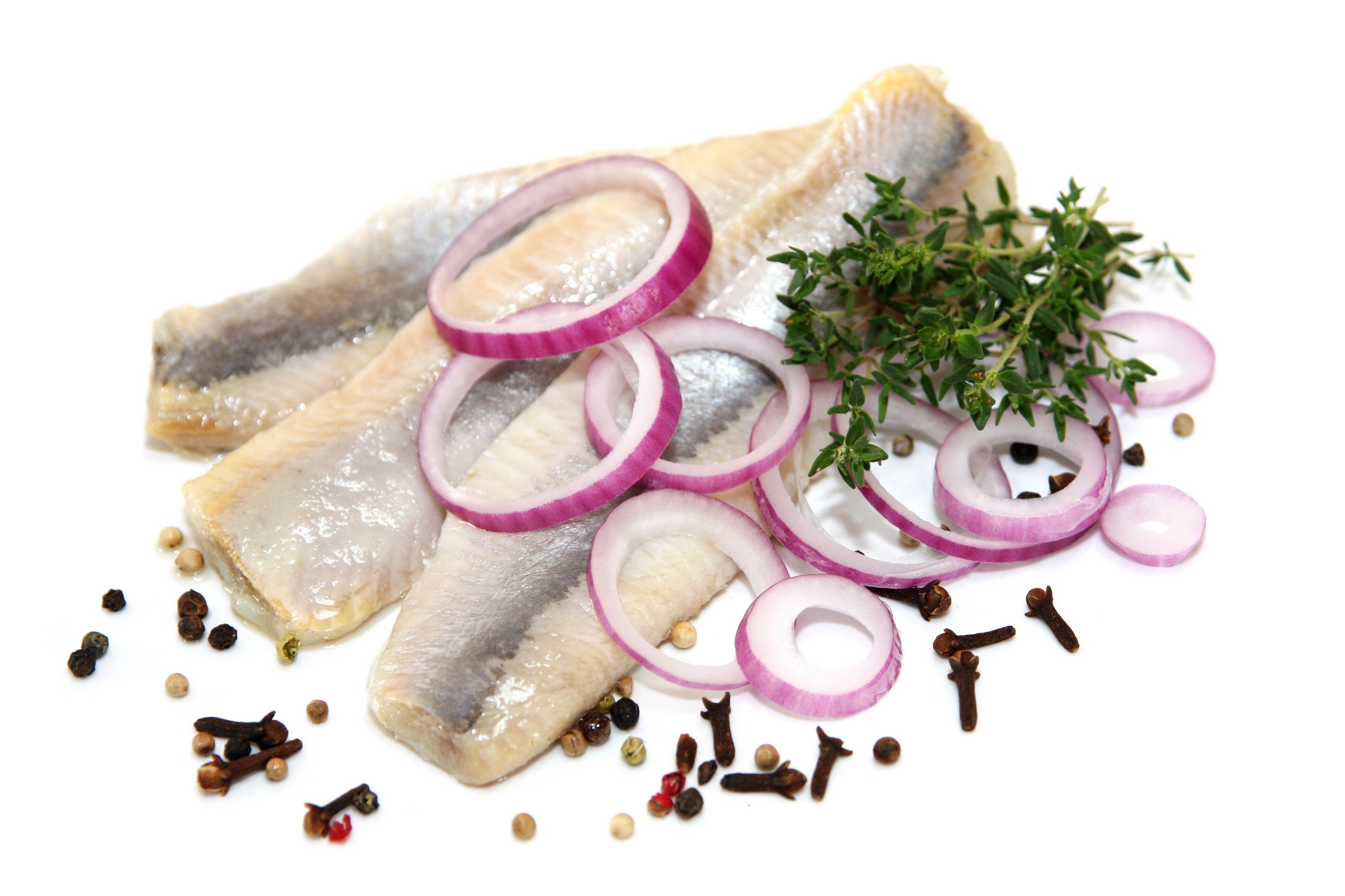 sliced fish with onions and herbs