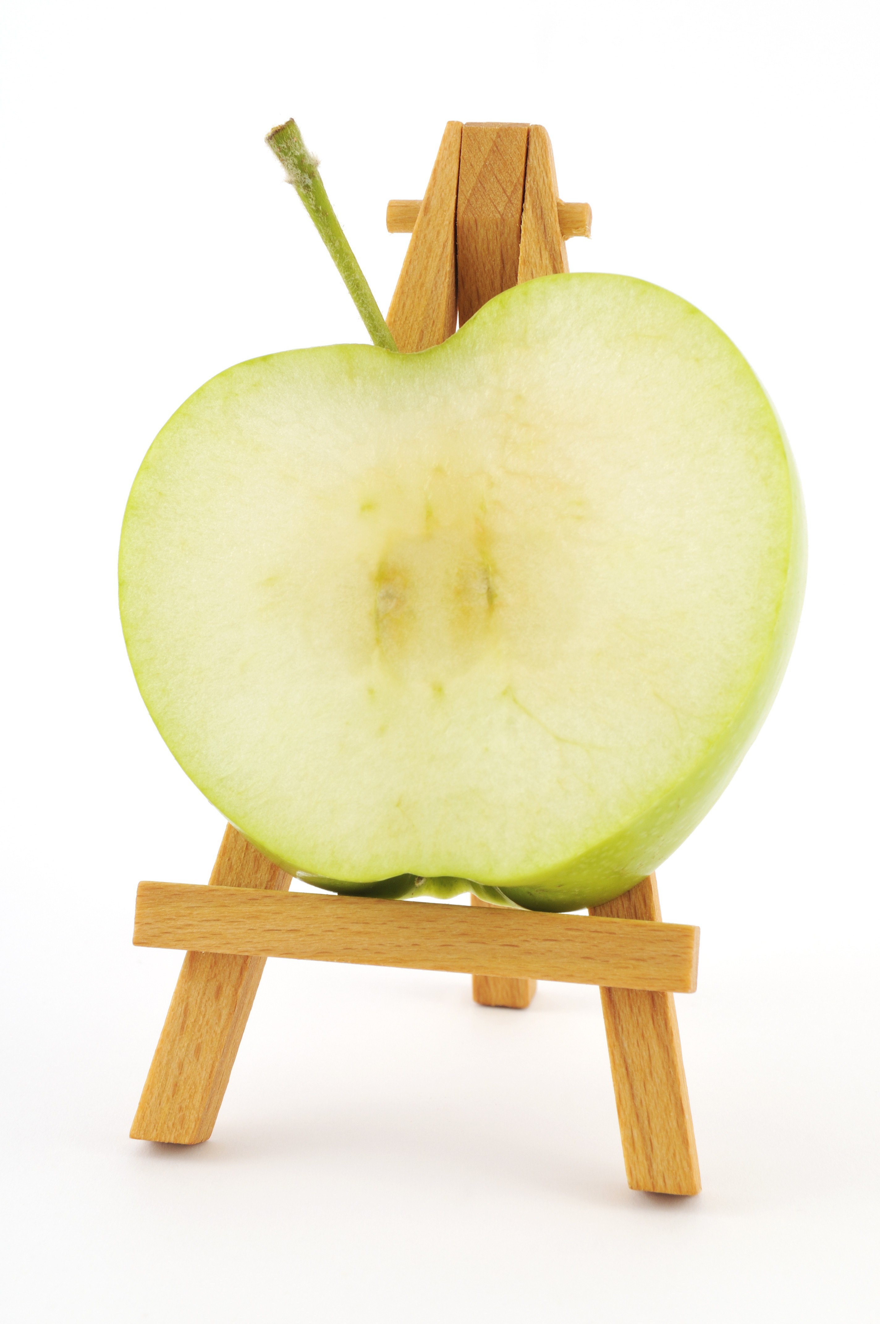sliced green apple on easel
