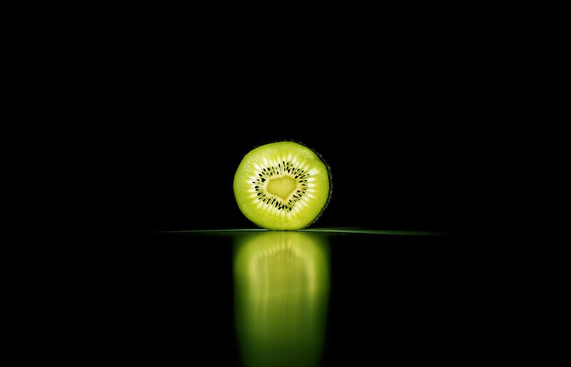 Sliced Kiwi Fruit — Green, Dramatic, Photograph, Reflection, Black Background