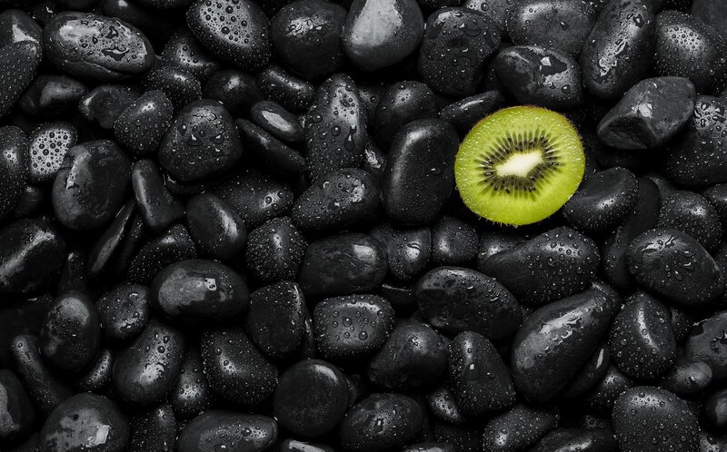 Sliced Kiwi on Black Stones