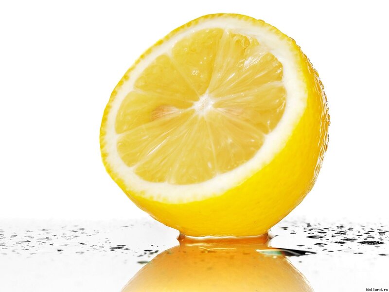 Sliced Lemon on Wet Surface — Yellow, Clean, Photograph
