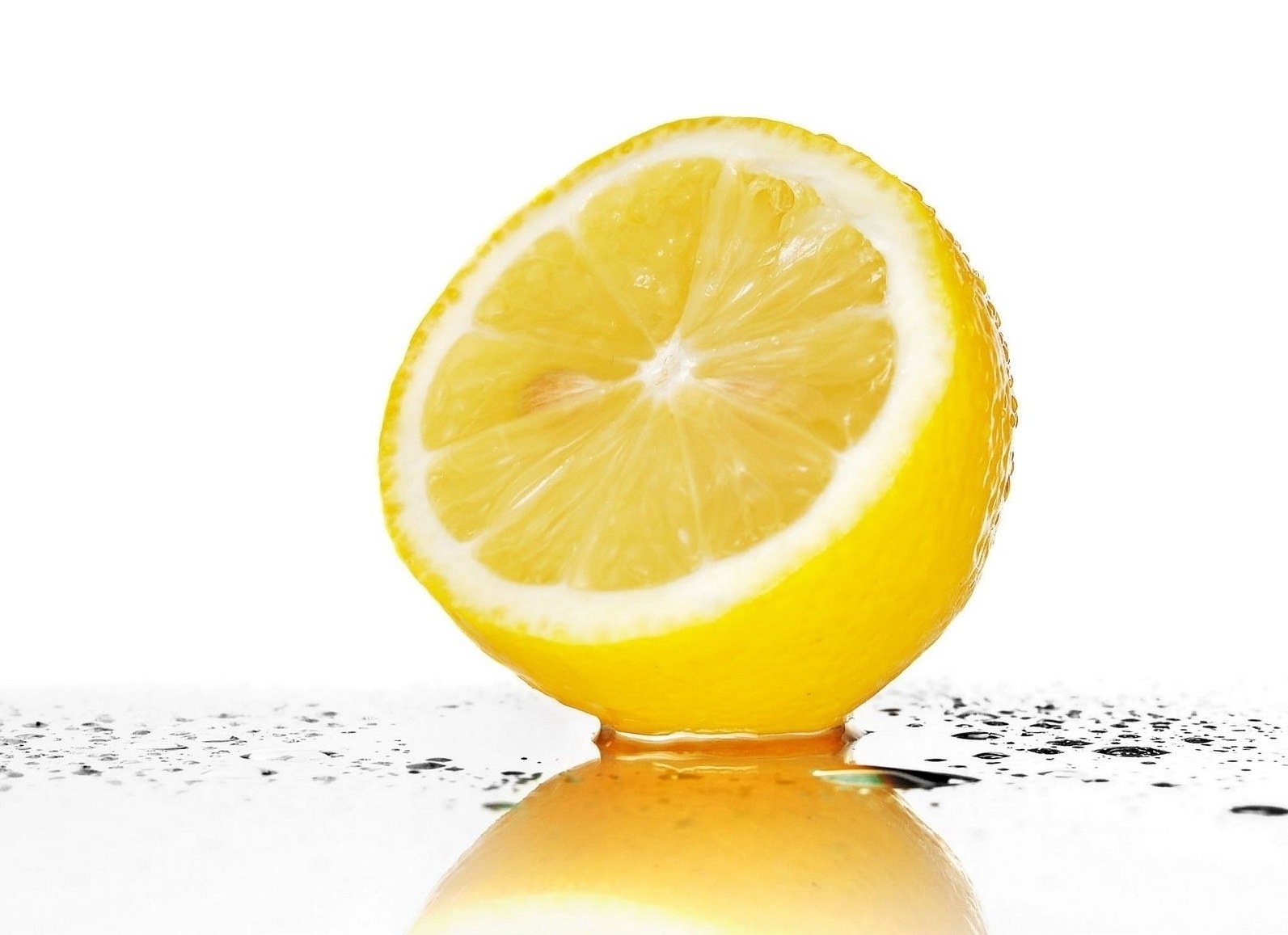 sliced lemon on white surface