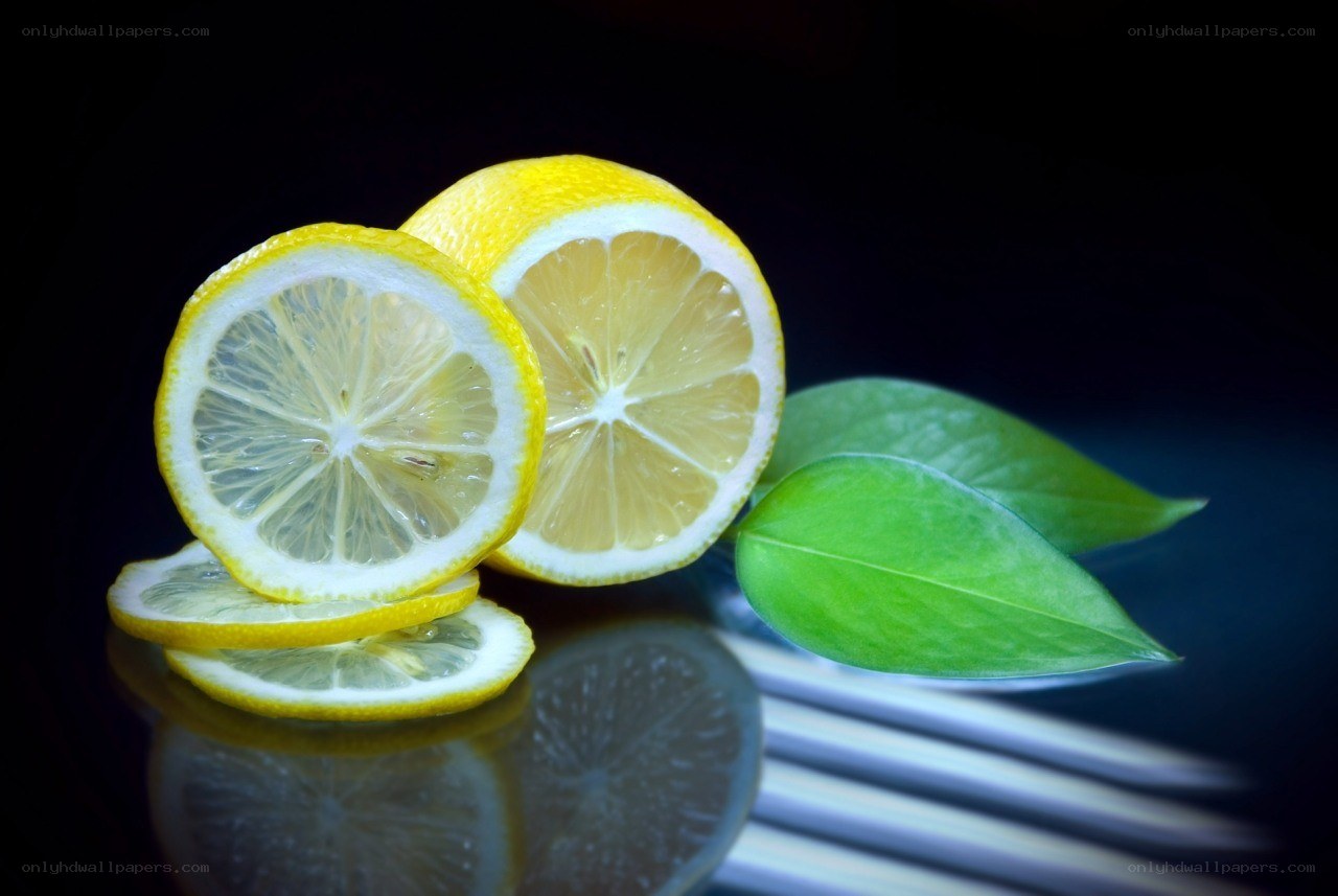 Sliced lemons with green leaves