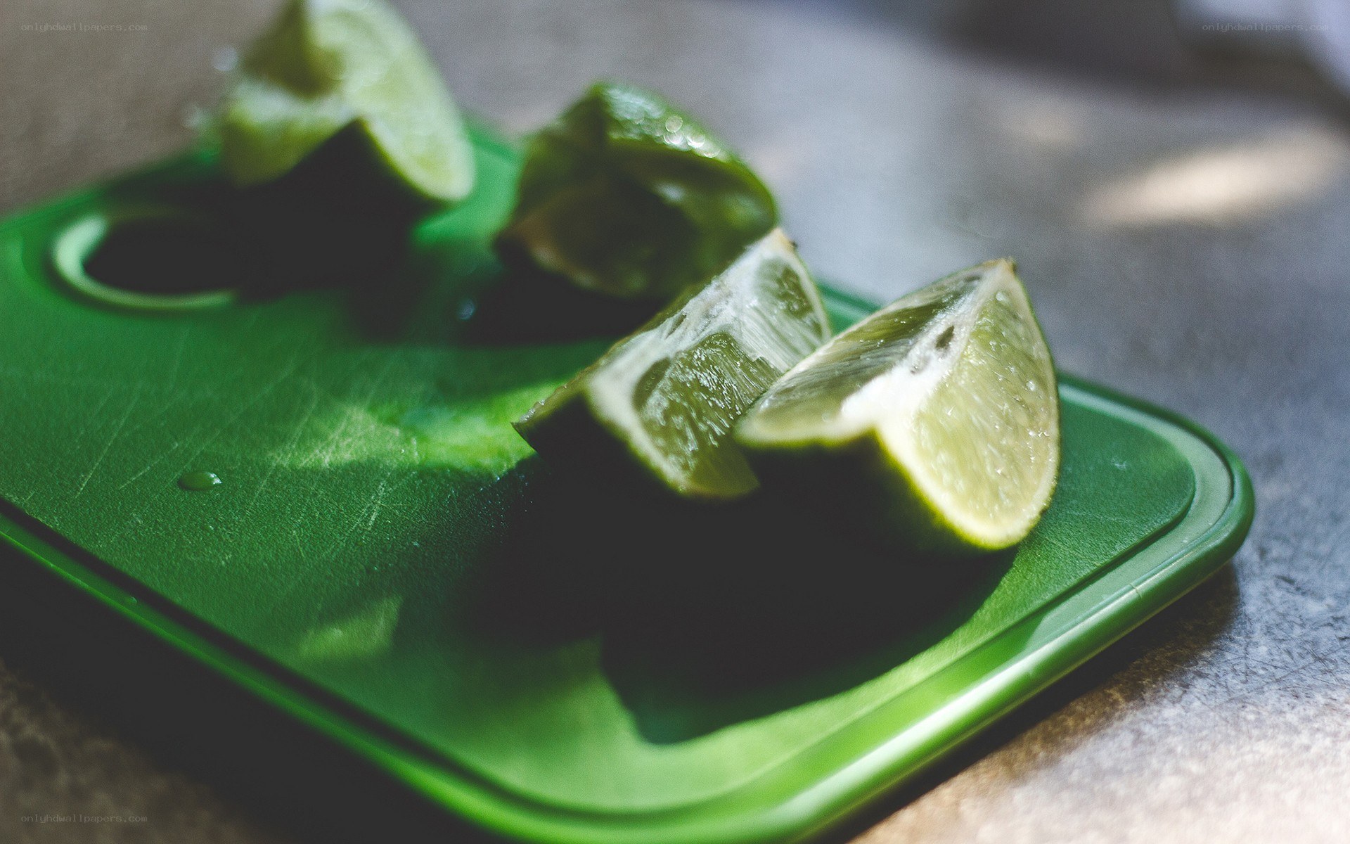 sliced limes on green board
