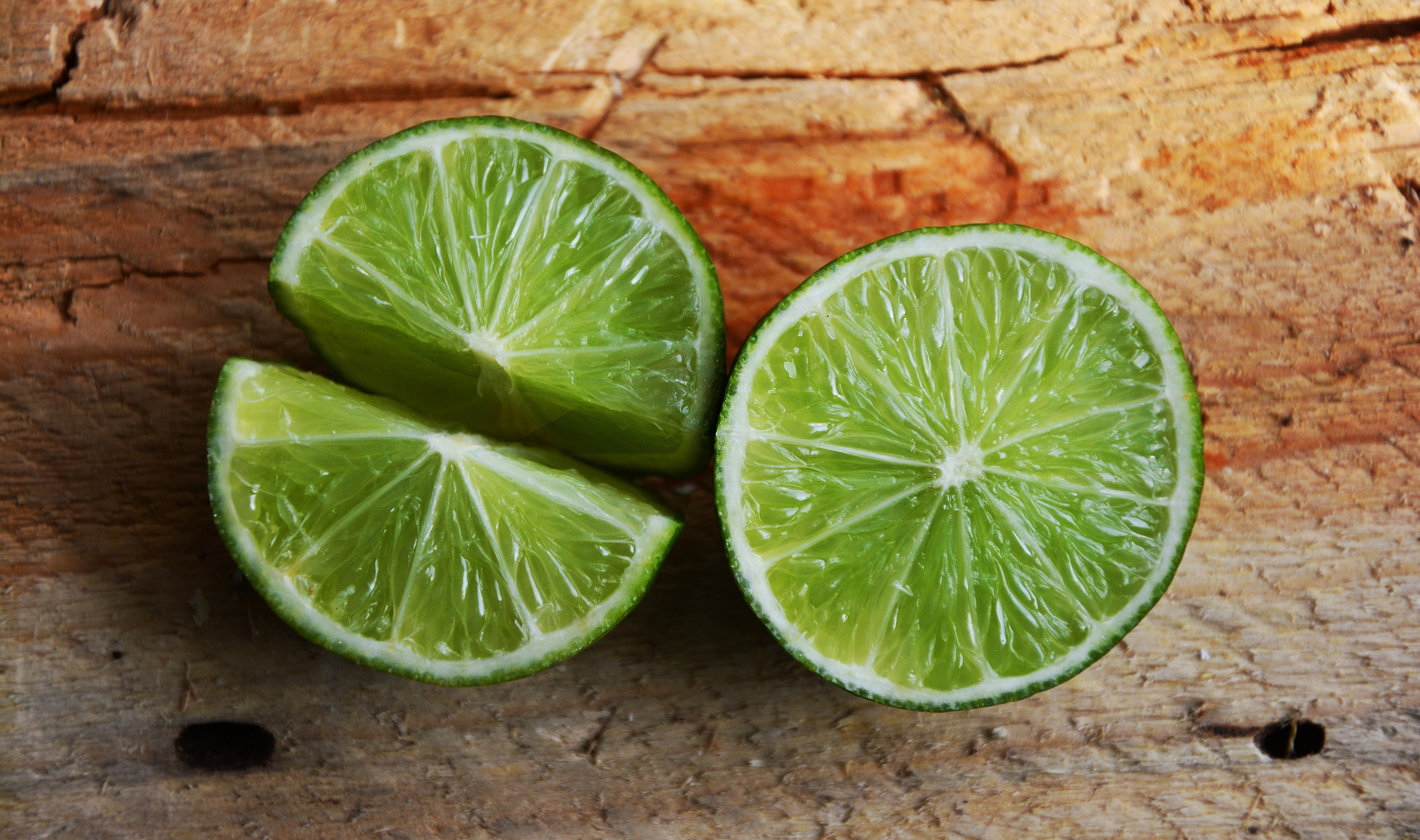 sliced limes on wood