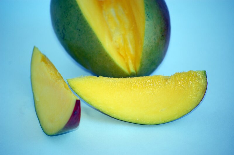 sliced mango on blue
