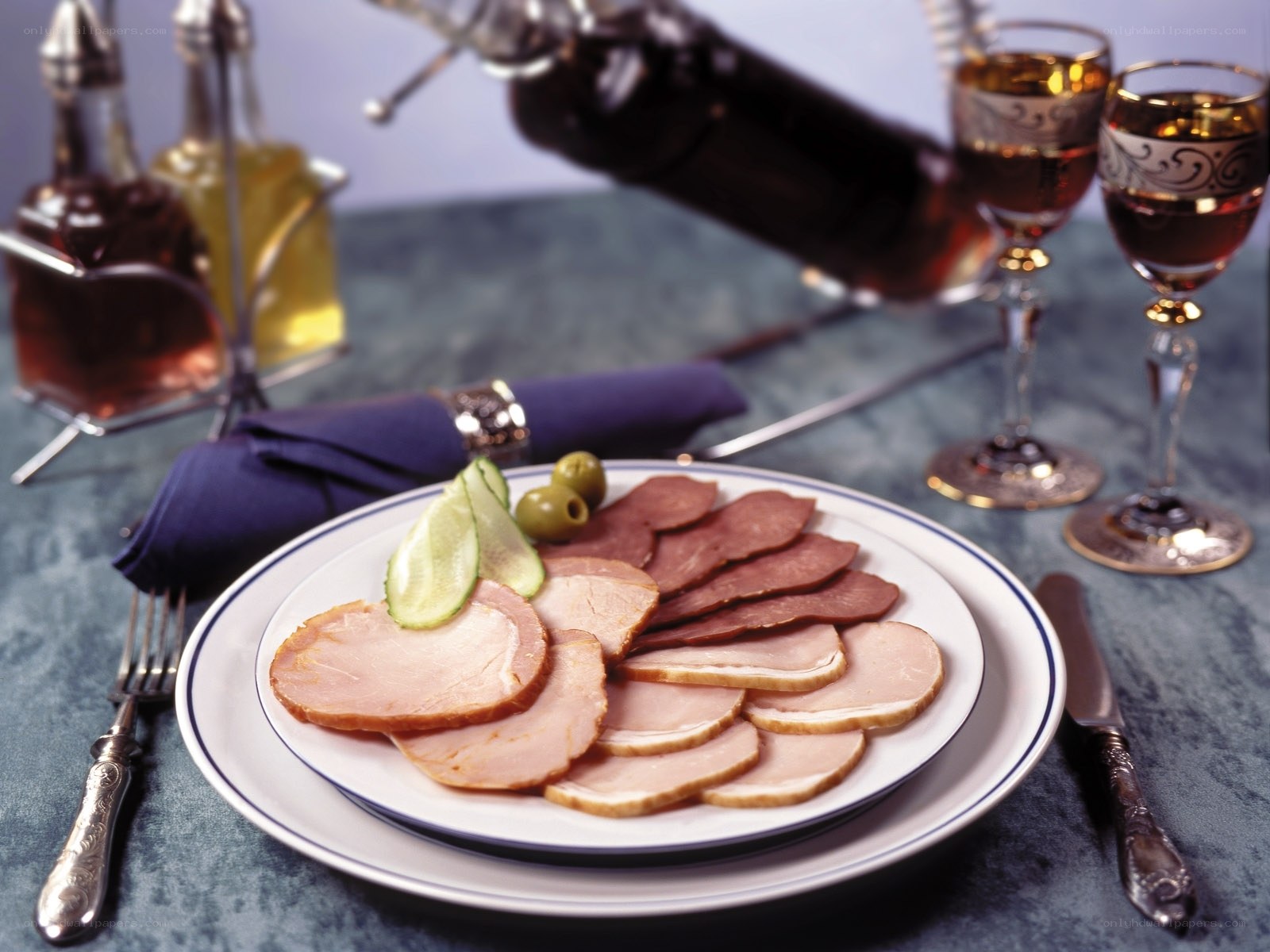 Sliced meats with olives and pickles