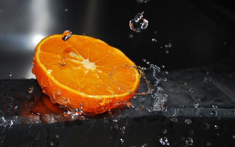 Sliced Orange Fruit — Black Surface