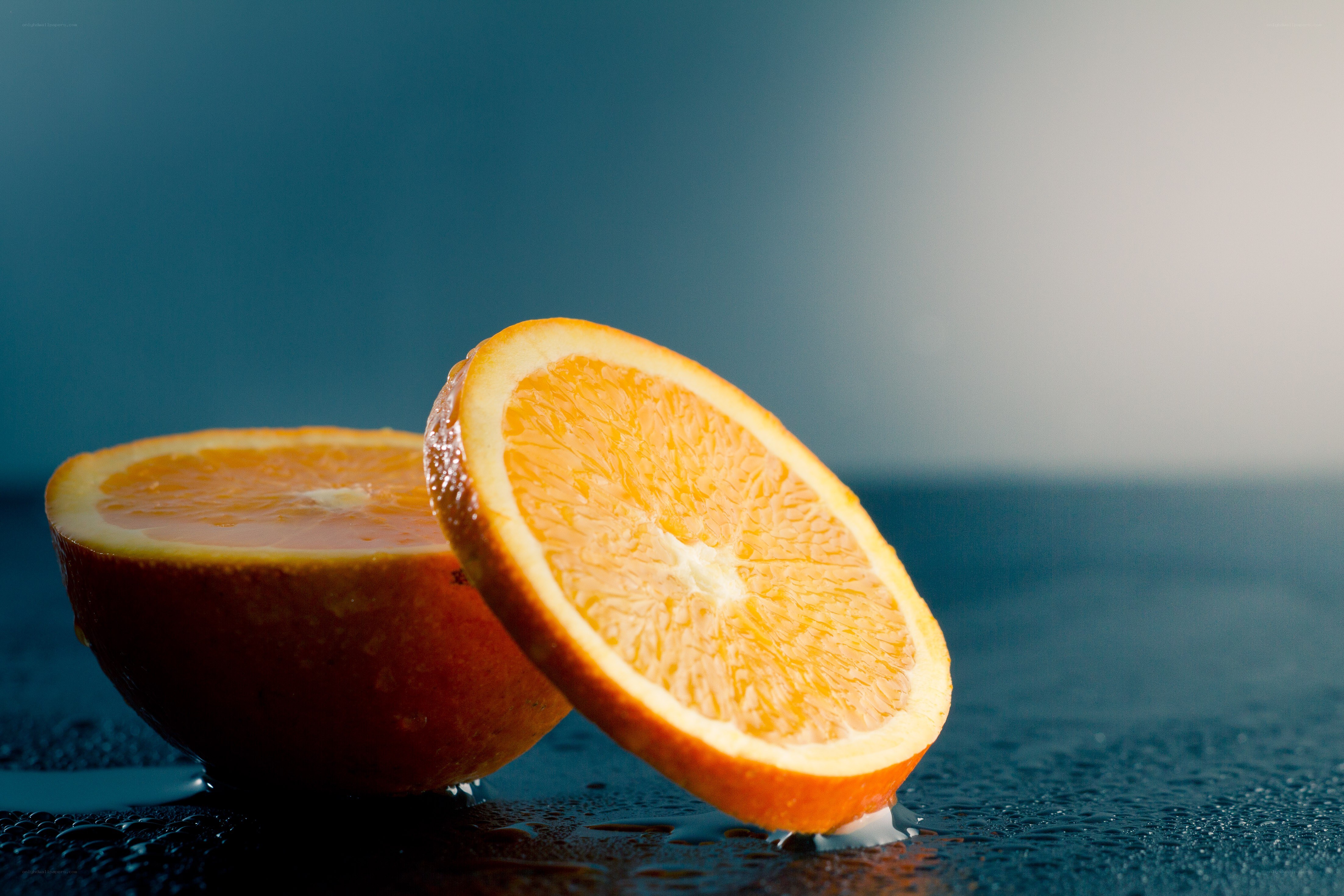 sliced orange on wet surface