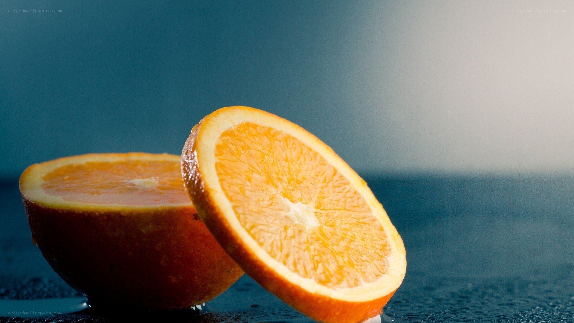sliced orange on wet surface