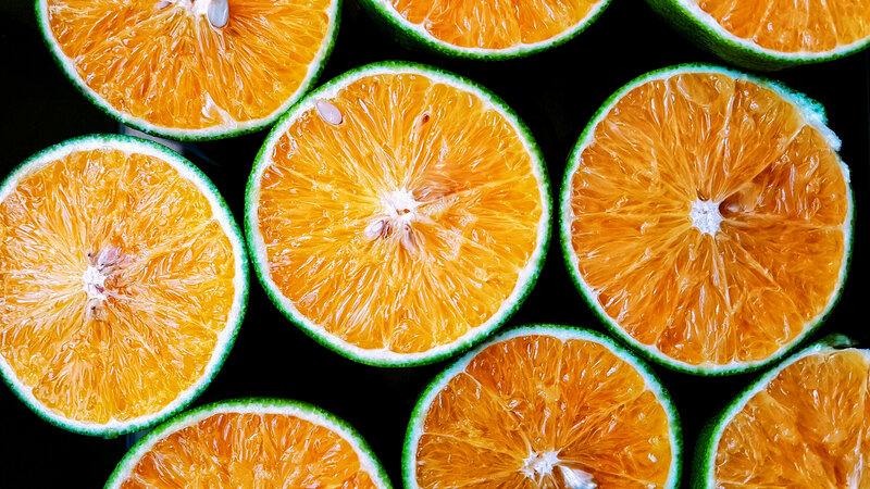 sliced oranges on black