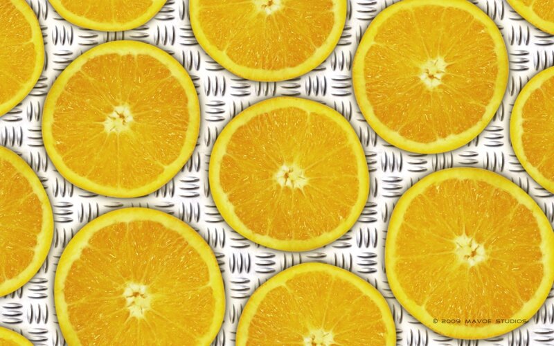 Sliced oranges on metal surface