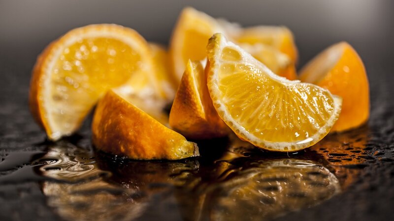 Sliced Oranges on Wet Surface — Orange