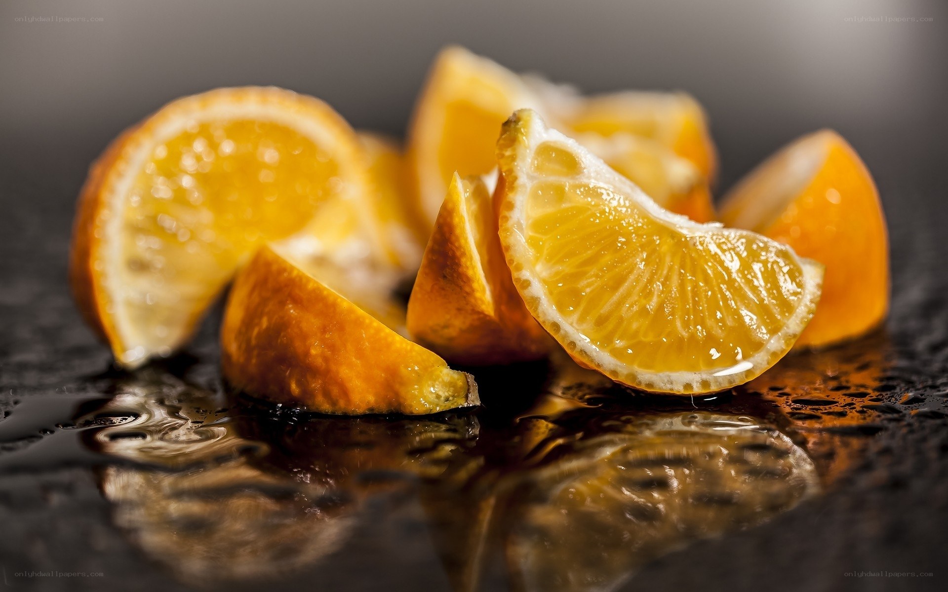 Sliced oranges on wet surface