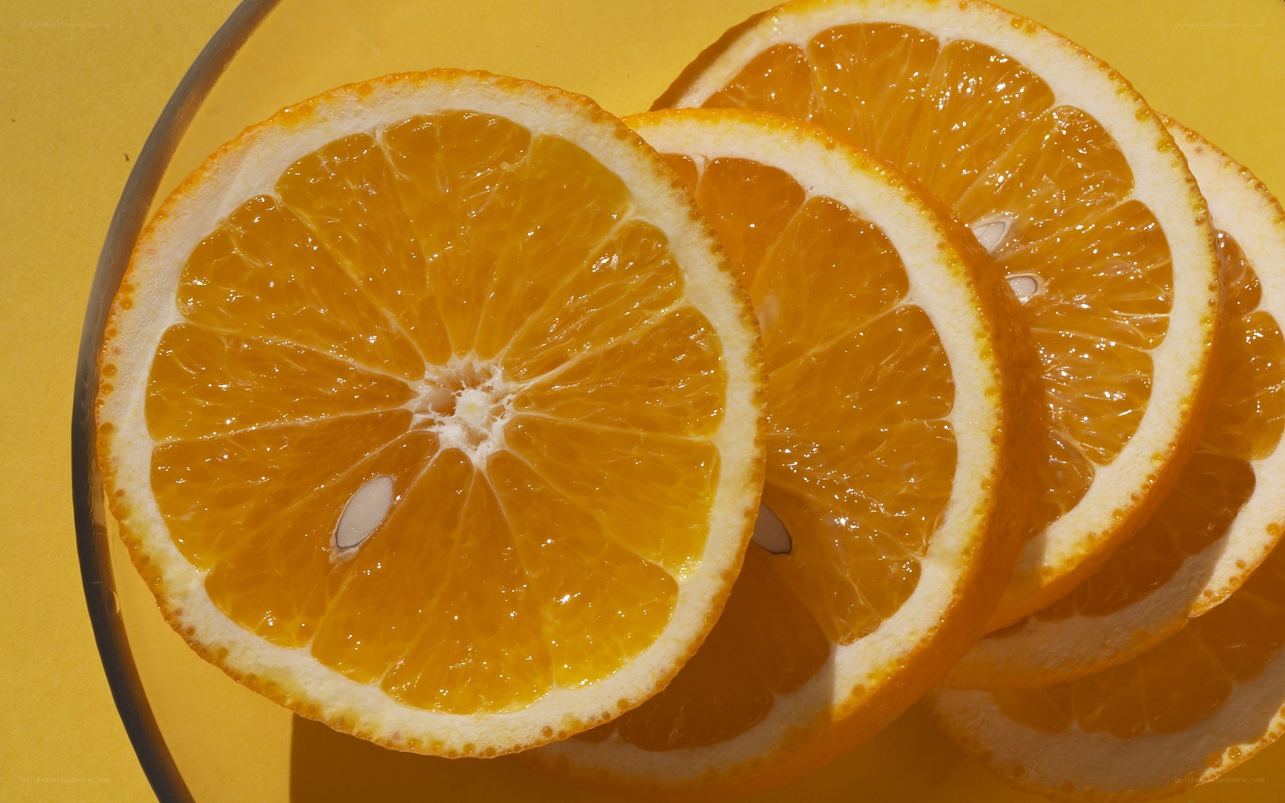 sliced oranges on yellow