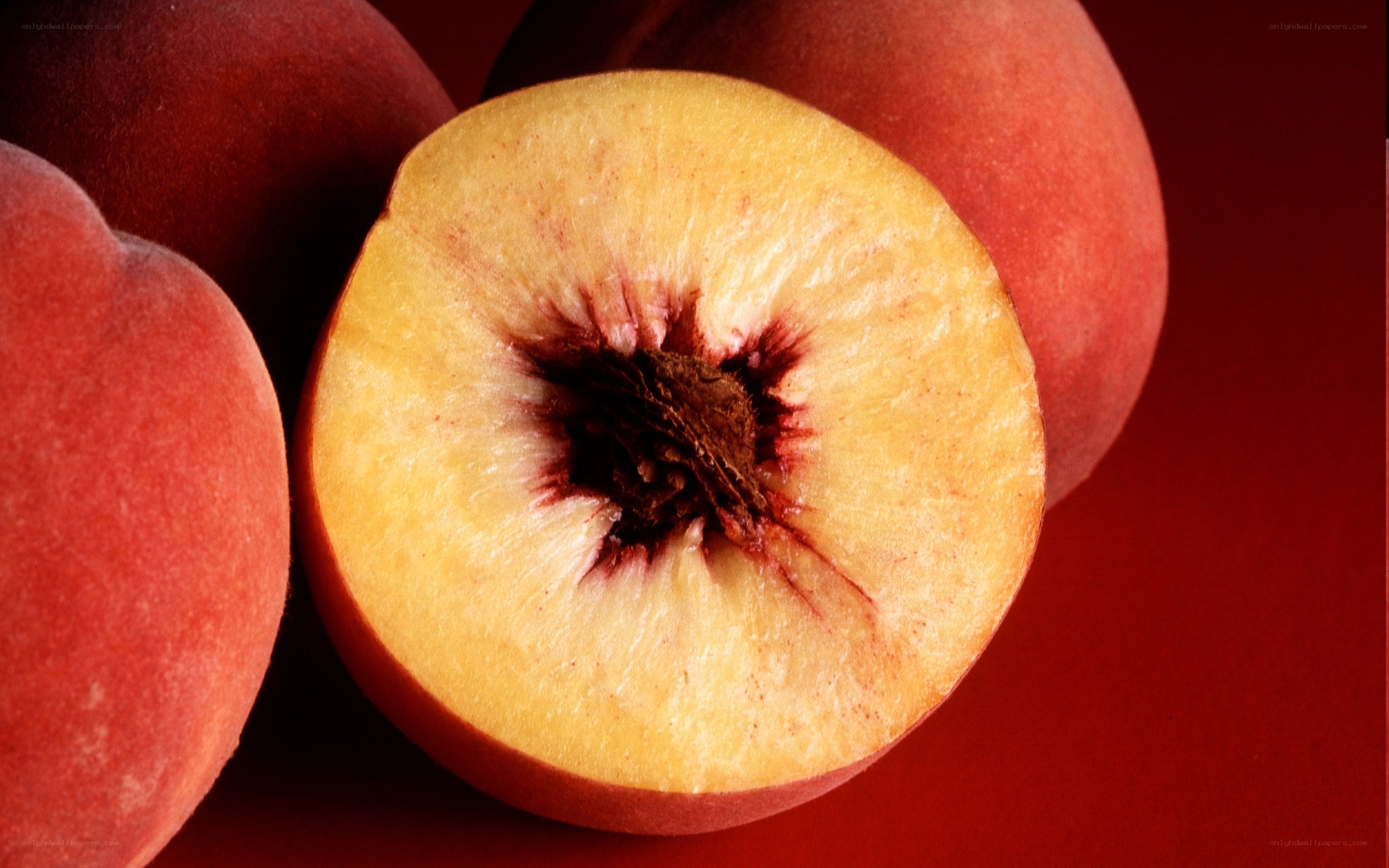 sliced peach on red background