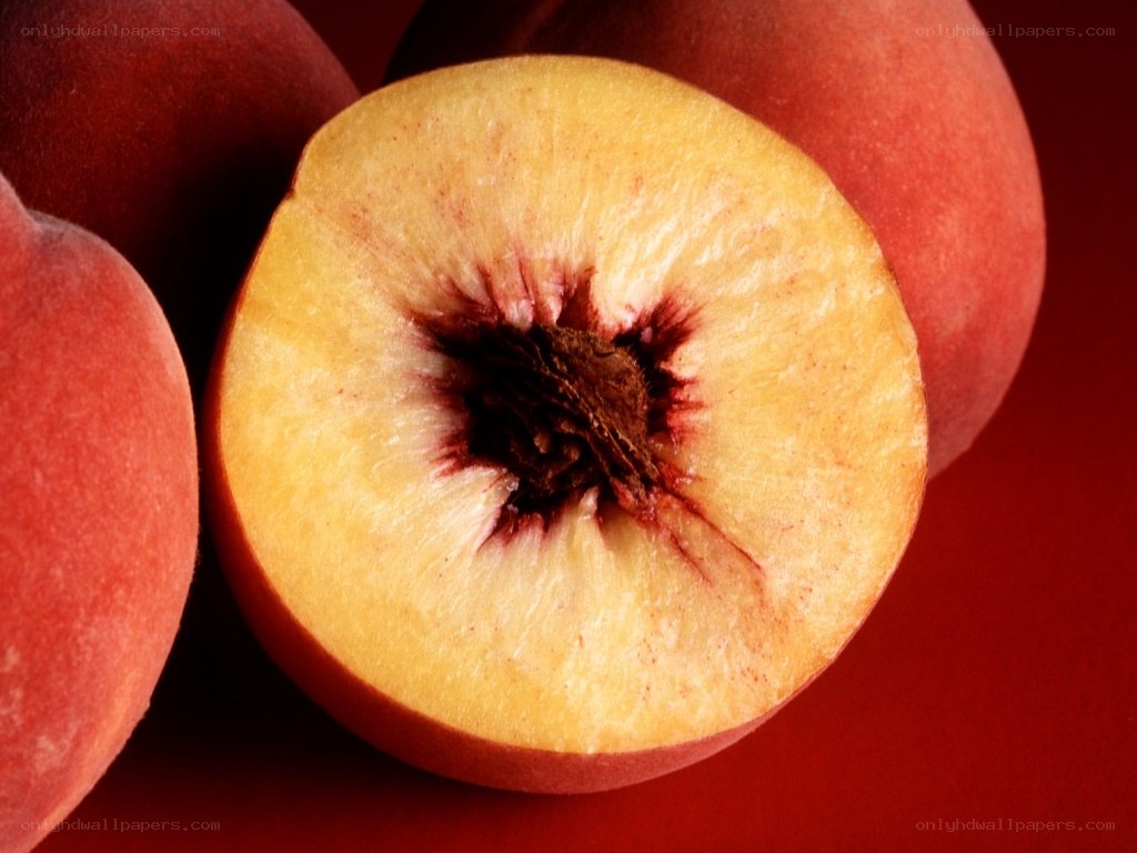 sliced peach on red background