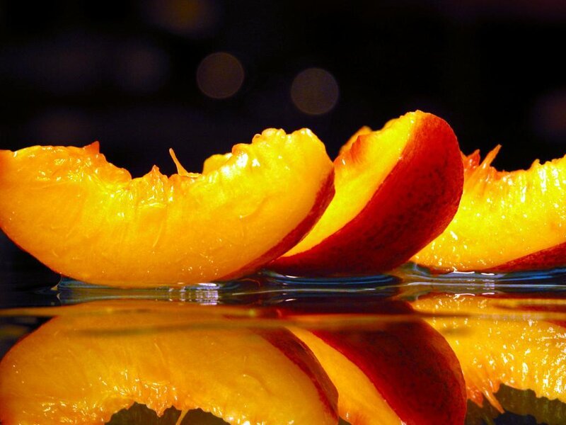 sliced peaches on water