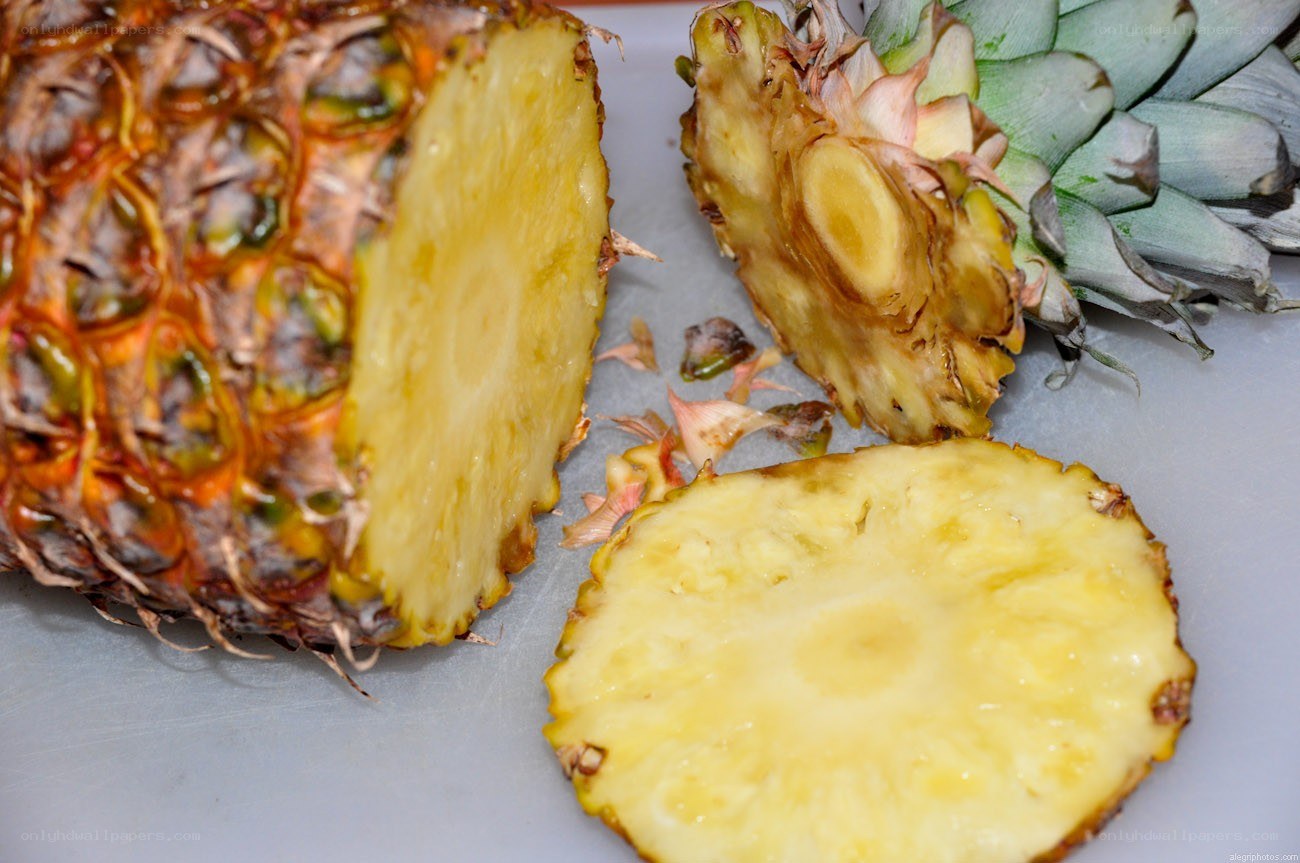 Sliced pineapple on cutting board