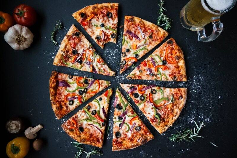 Sliced Pizza on Black Surface