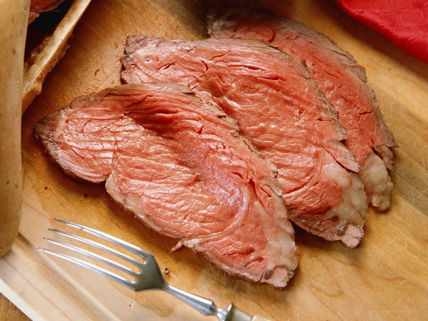 Sliced roast beef on cutting board