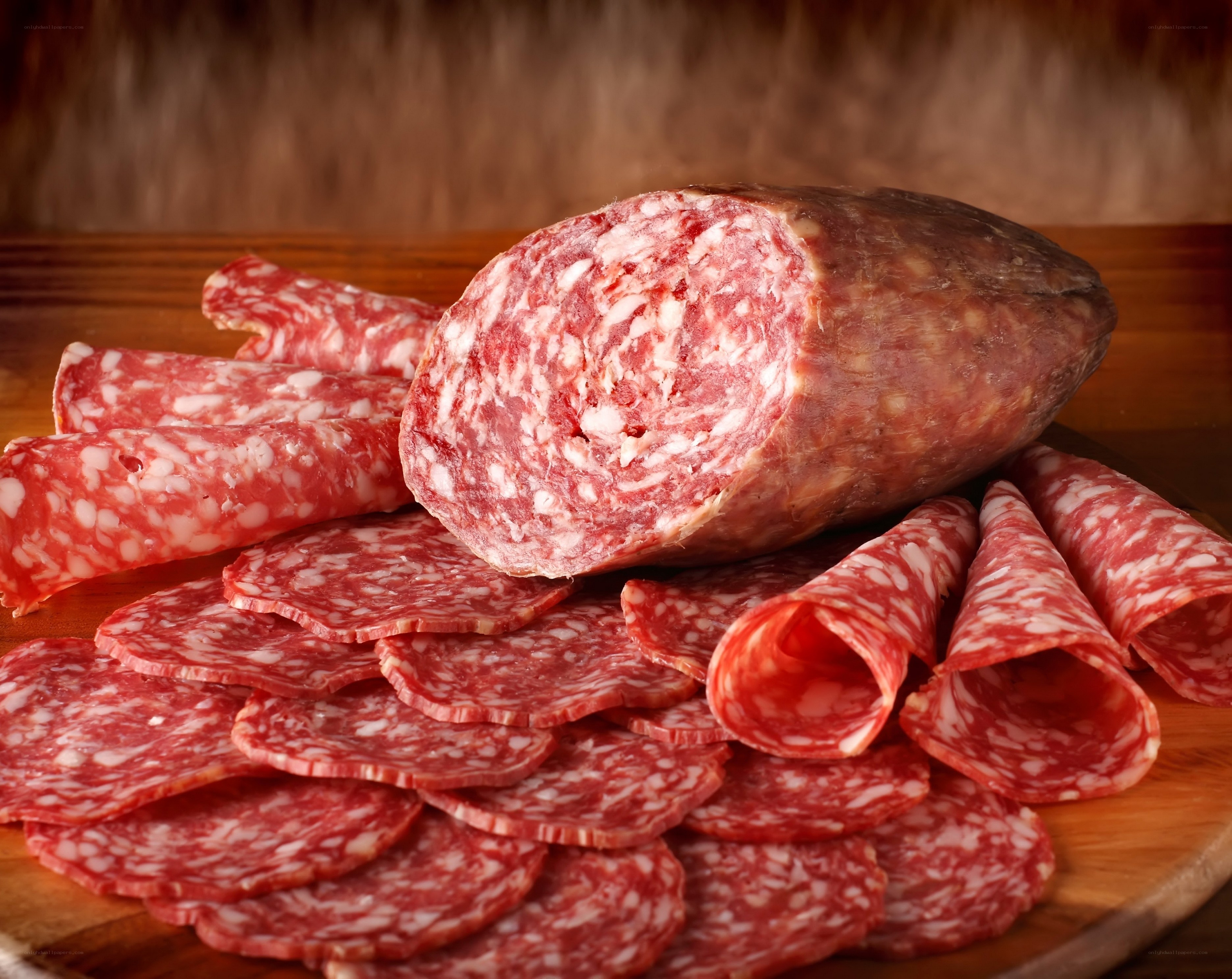 sliced salami on wooden board