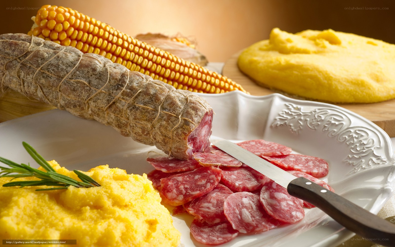 Sliced salami with polenta and corn