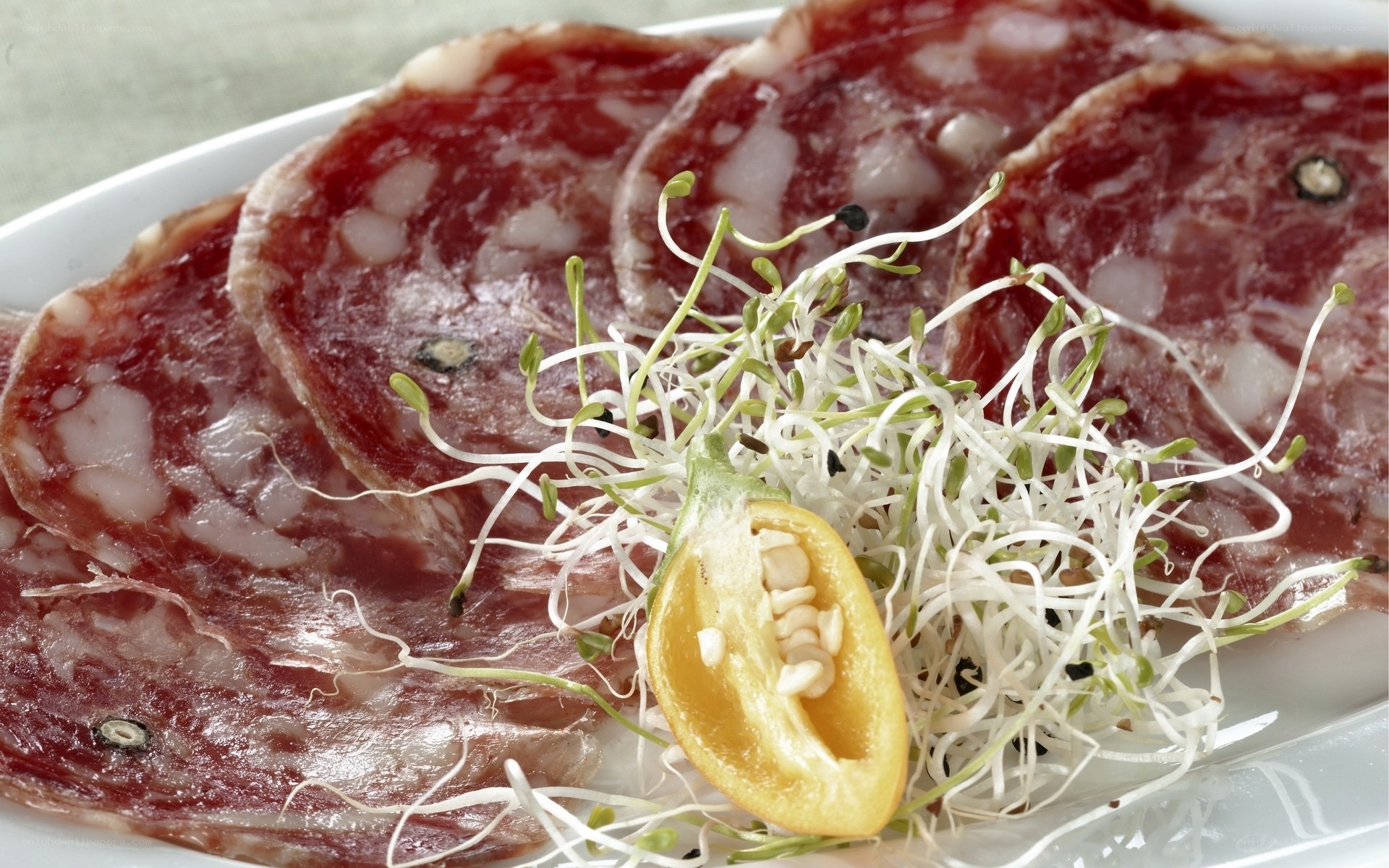 Sliced salami with sprouts