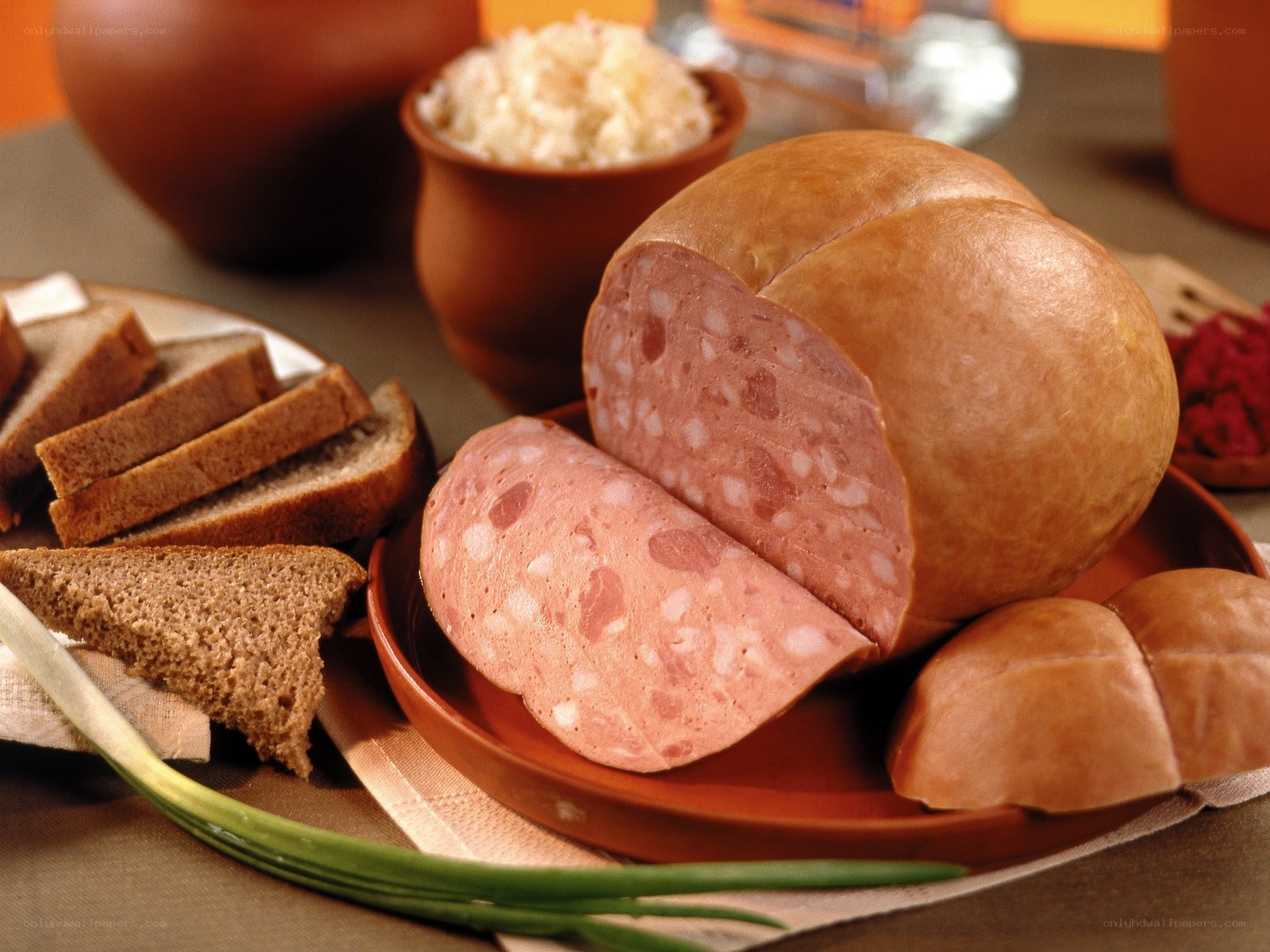 Sliced sausage with bread and sides