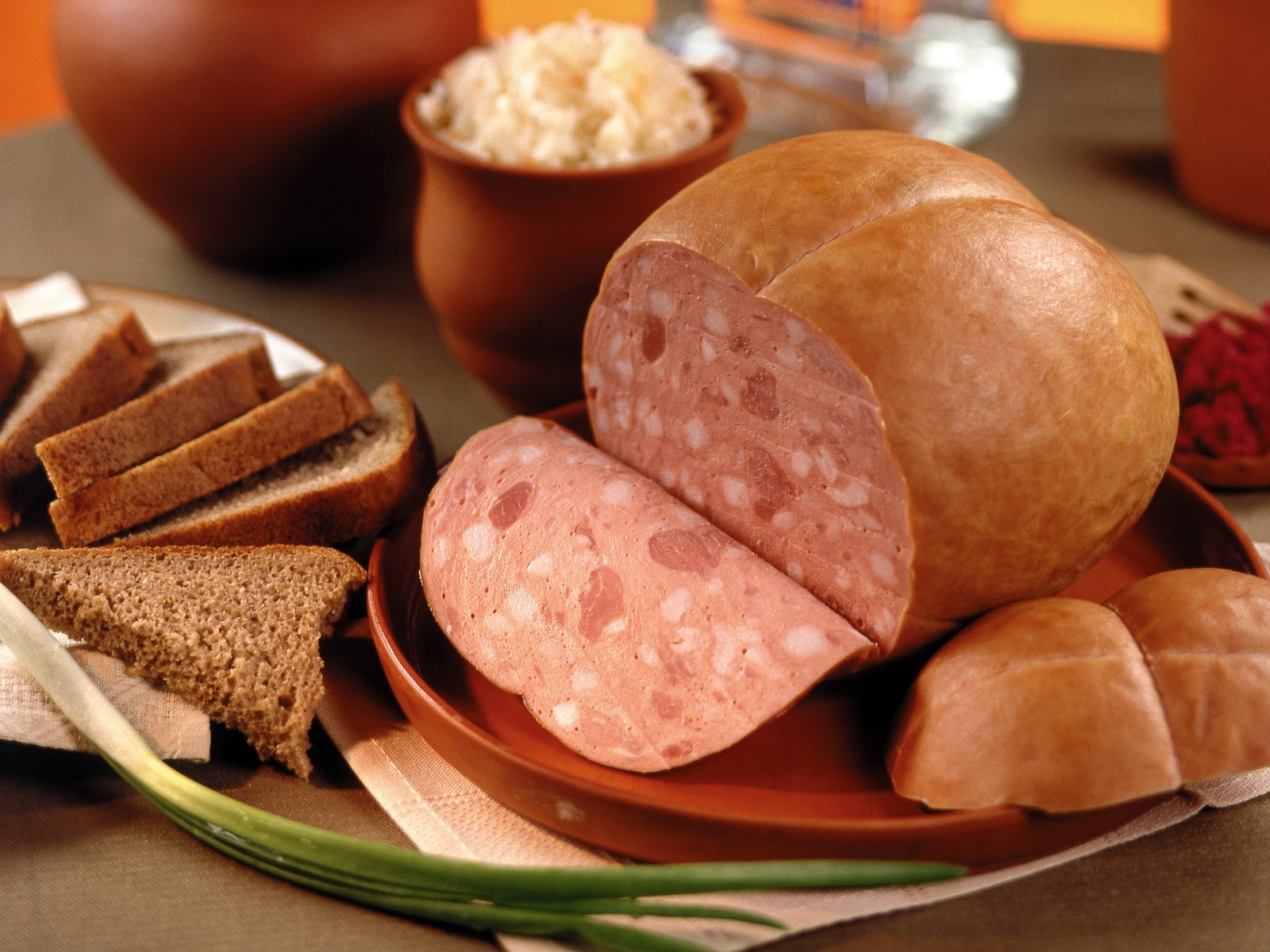Sliced sausage with bread and sides