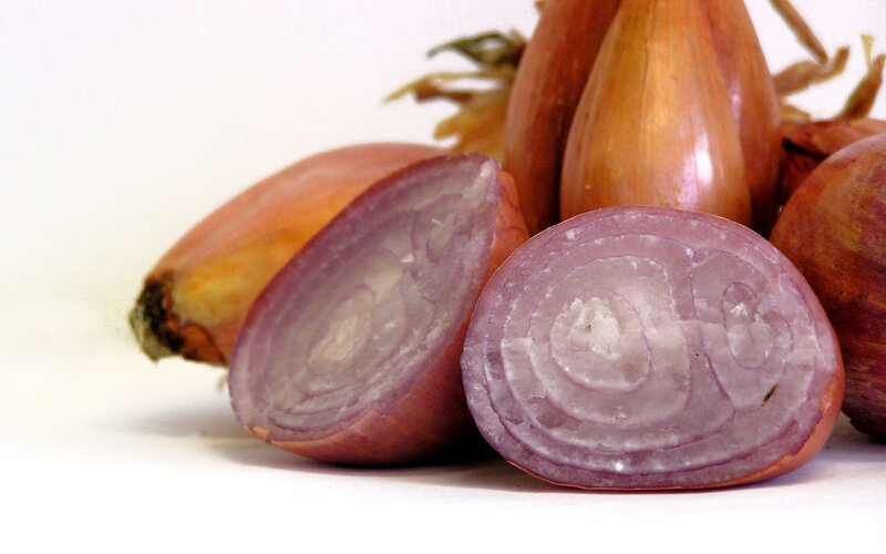 sliced shallots on white
