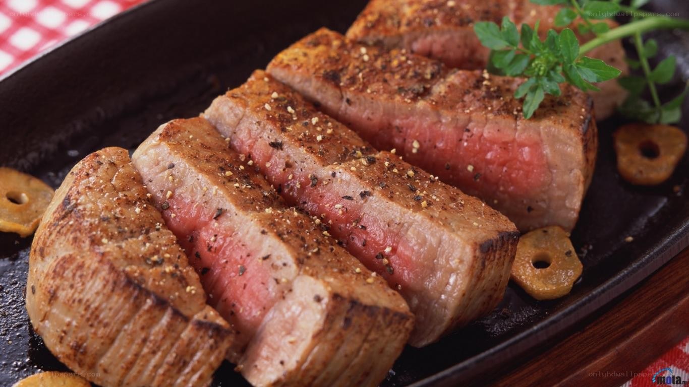 Sliced steak on a hot plate