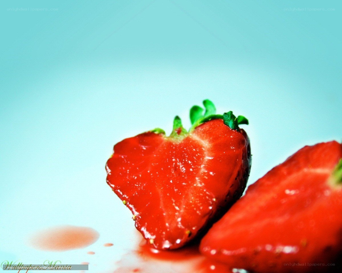 sliced strawberries on blue