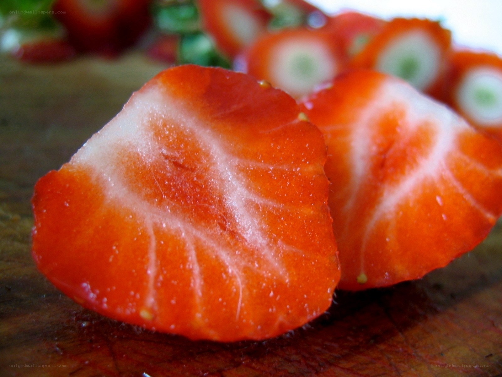 sliced strawberries on wood