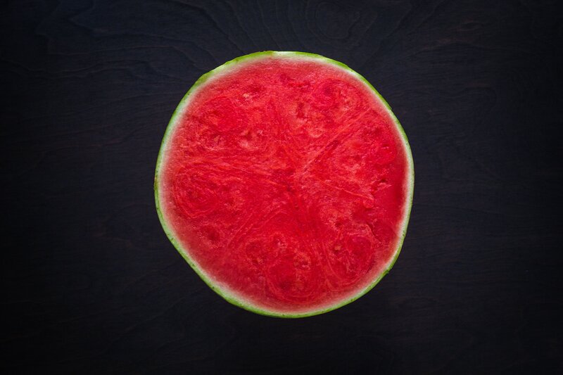sliced watermelon on dark surface