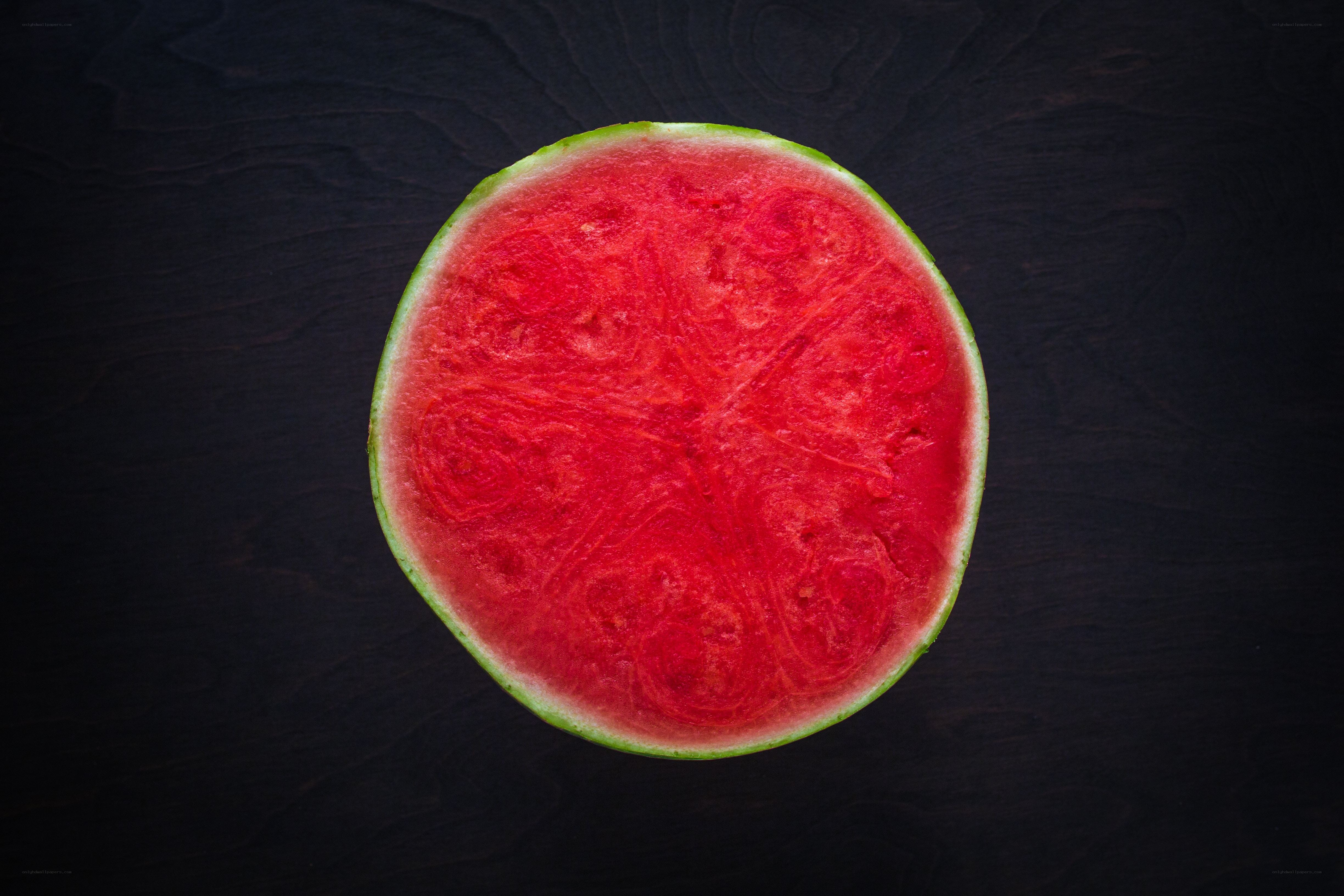 sliced watermelon on dark surface