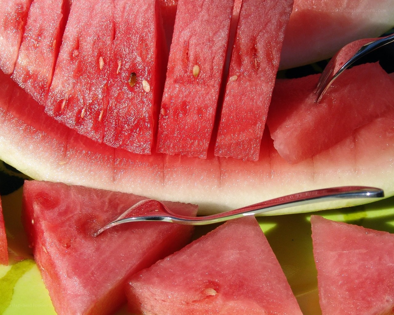 sliced watermelon with fork