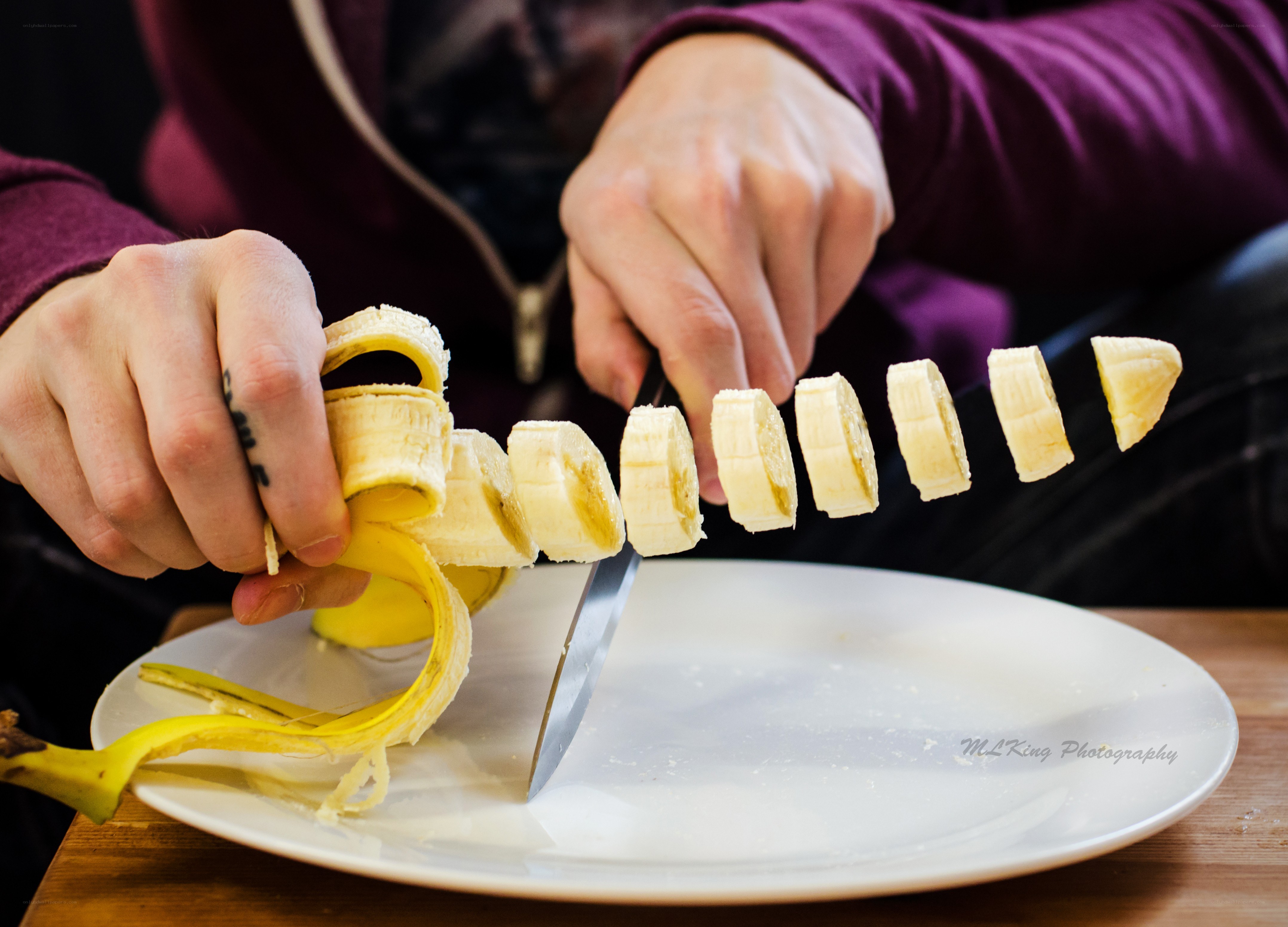 slicing a banana with knife