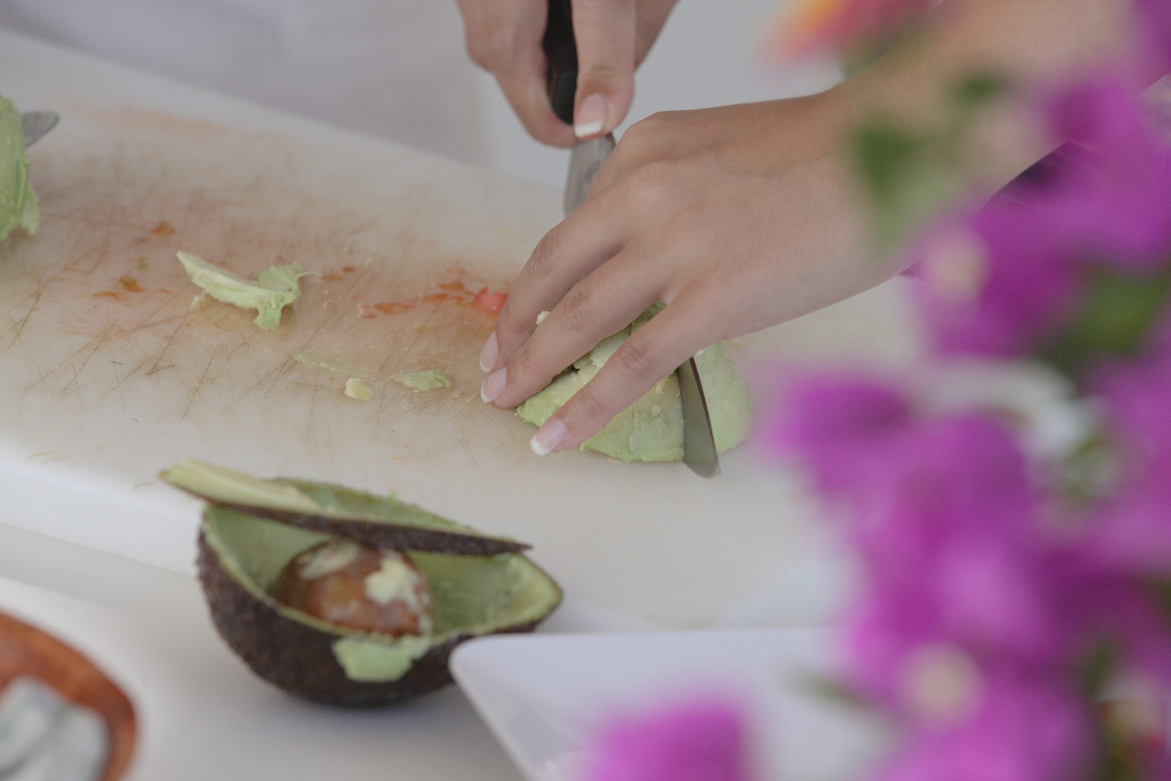 Slicing avocado on a cutting board