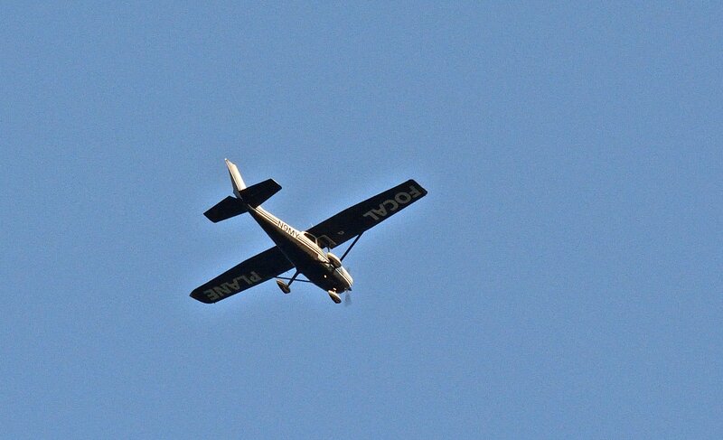 Small Airplane in Flight — Blue, Calm