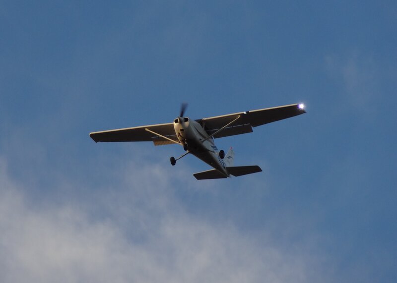 Small Airplane in Flight — Blue