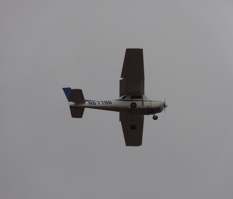 Small Airplane in Flight — Gray, Overcast