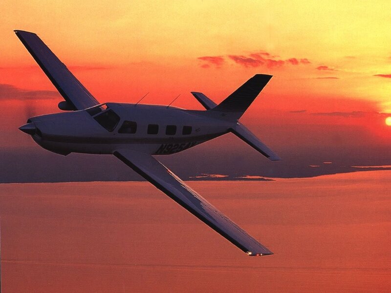 Small Airplane in Flight — Orange
