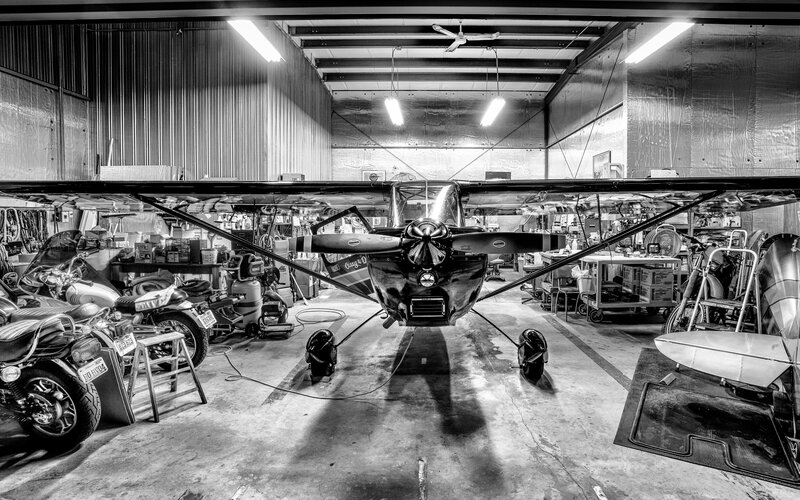 Small Airplane in Hangar — Black