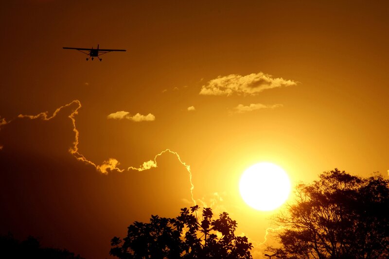 Small Airplane in Sky — Orange